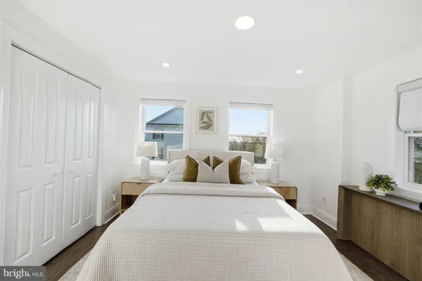 a bedroom with a bed and a potted plant