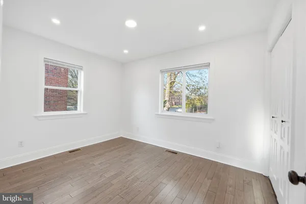 a view of room with hardwood floor and window