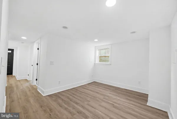 a view of a room with wooden floor