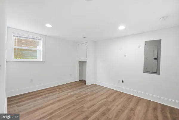 a view of empty room with wooden floor