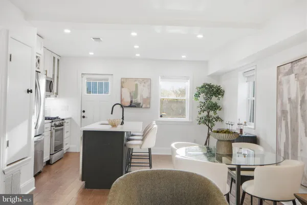 a living room with furniture a large window and a sink