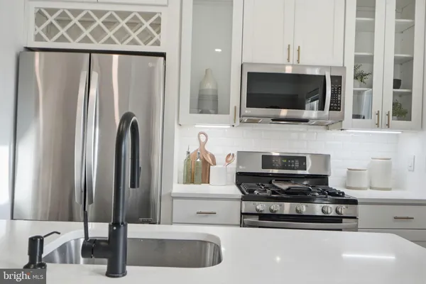 a kitchen with stainless steel appliances a stove a microwave and cabinets