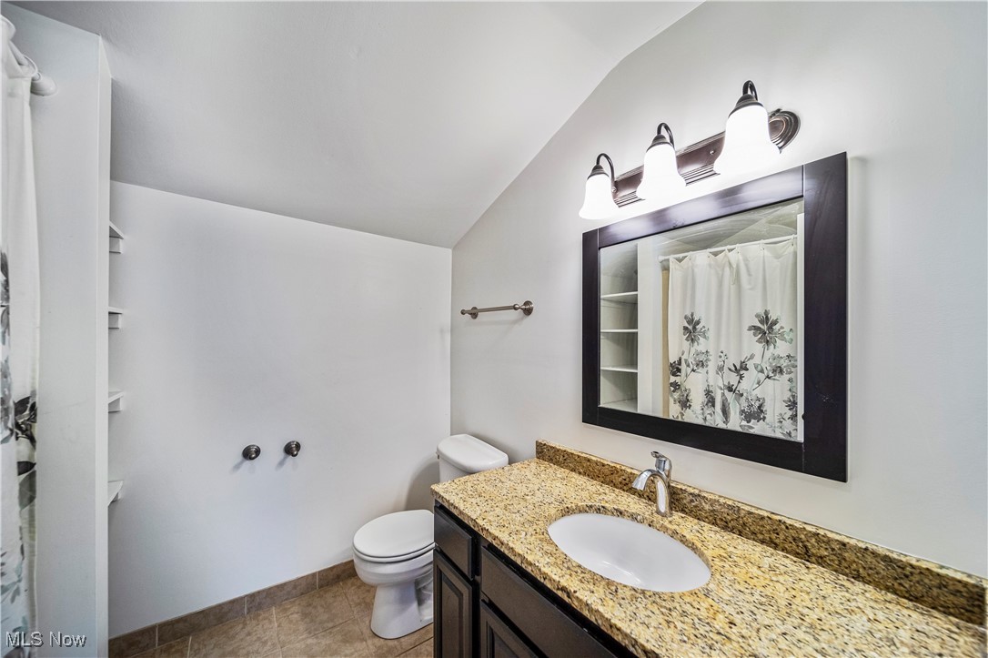 1796 Lander Road Mayfield Heights, OH 44124 - Photo 30 of 39 Bathroom with tile patterned floors, vaulted ceiling, vanity, and toilet