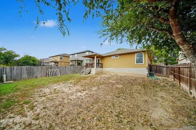 a backyard of a house with wooden fence