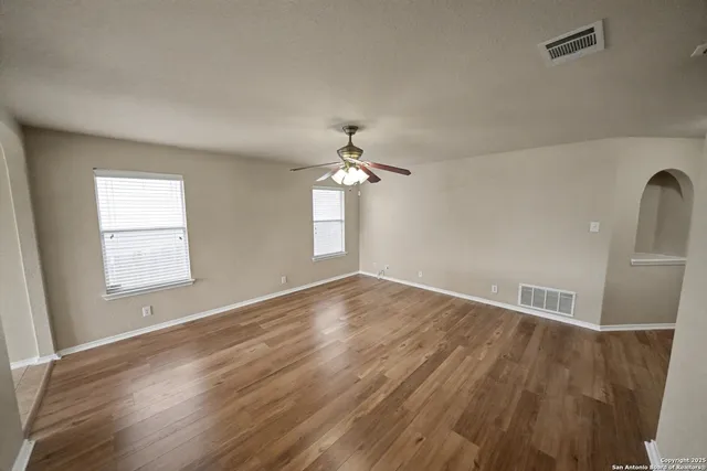 wooden floor in an empty room with a window
