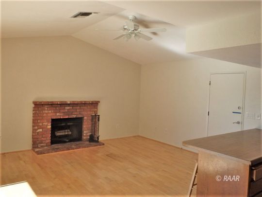 633 South Gemstone Street Ridgecrest, CA 93555 - Photo 10 of 35 a room with a fireplace and cabinets