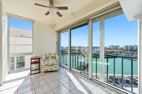 a bedroom with furniture and large window