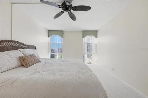a spacious bedroom with a bed and a chandelier