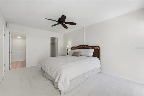 a bedroom with a bed and a ceiling fan