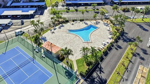 a view of a swimming pool with sitting area