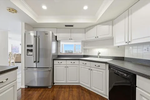 a kitchen with white cabinets and stainless steel appliances