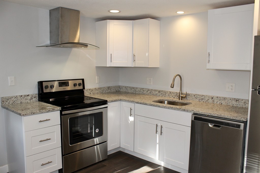 4 Jon Street Salisbury, MA 01952 - Photo 13 of 27 a kitchen with granite countertop a stove sink and cabinets