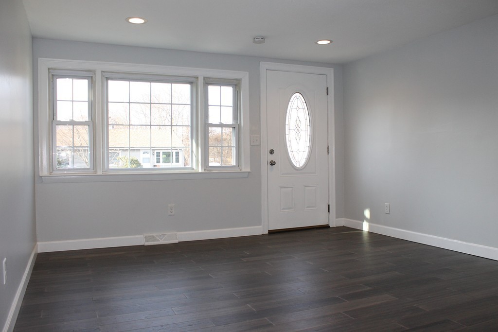 4 Jon Street Salisbury, MA 01952 - Photo 15 of 27 an empty room with wooden floor and windows