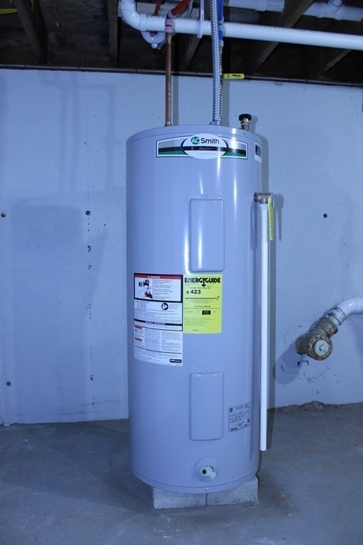 4 Jon Street Salisbury, MA 01952 - Photo 22 of 27 a room with painting and a chandelier