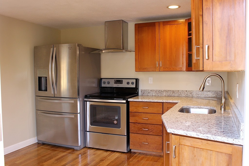 4 Jon Street Salisbury, MA 01952 - Photo 4 of 27 a kitchen with stainless steel appliances granite countertop a sink stove and refrigerator