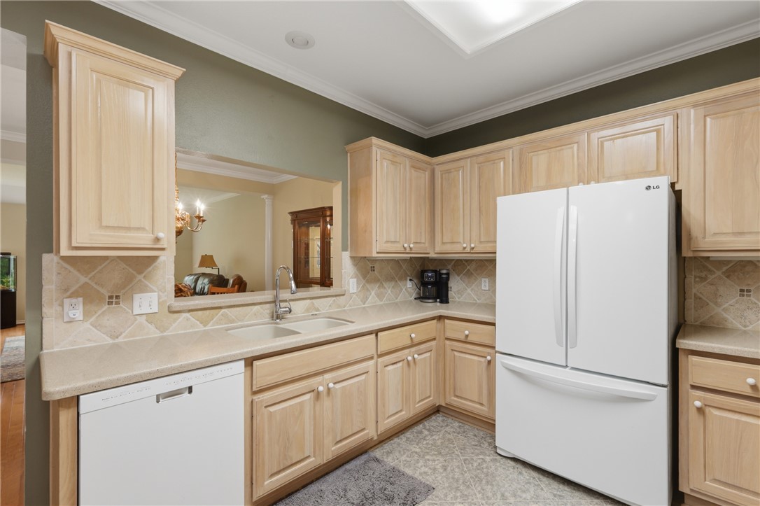 1520 Bennett Street Bryan, TX 77802 - Photo 11 of 24 a kitchen with white cabinets and white appliances