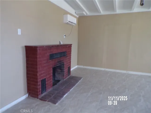 a view of an empty room with a fireplace