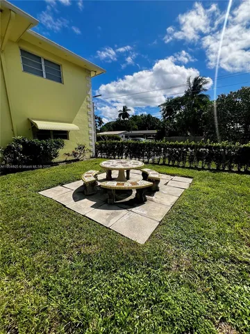 a view of a house with backyard patio and swimming pool