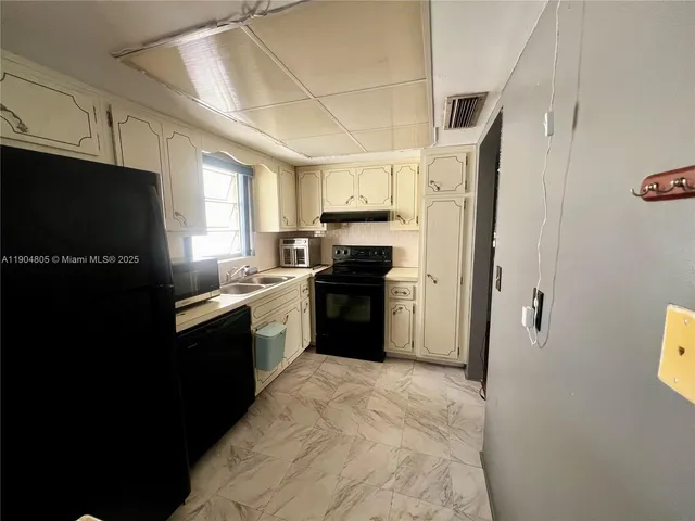 a kitchen with a refrigerator a sink and a stove