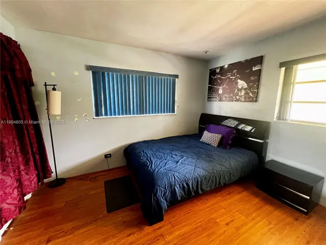 a bed sitting in a bedroom next to a window