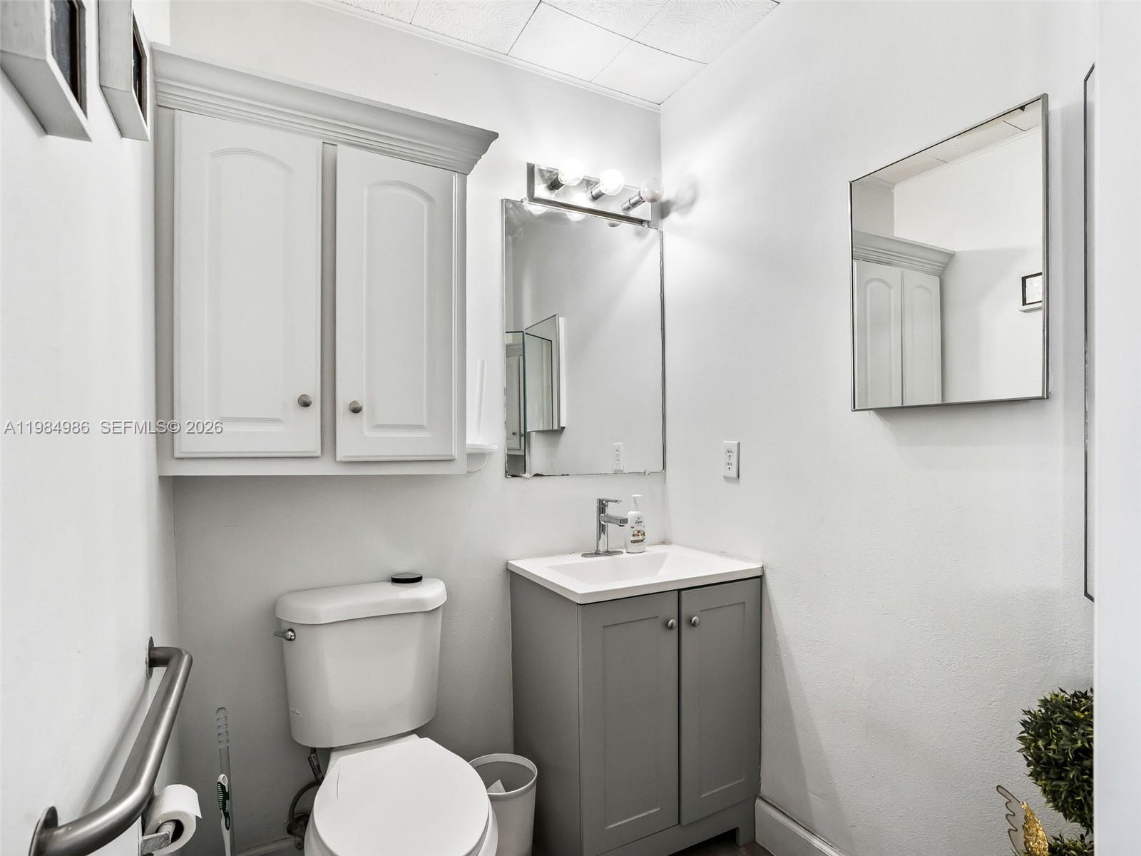 9594 Southeast Maricamp Road Ocala, FL 34472 - Photo 30 of 45 a bathroom with a toilet sink and mirror