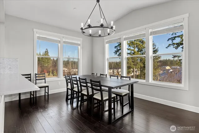 a view of a dining room with furniture wooden floor and chandelier