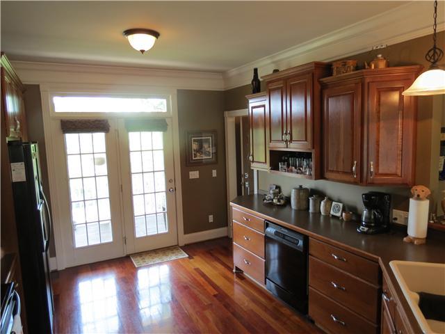 BRAZILIAN CHERRY HARD WOOD FLOORS. FRENCH DOORS LEADING OUT TO COVERED PORCH