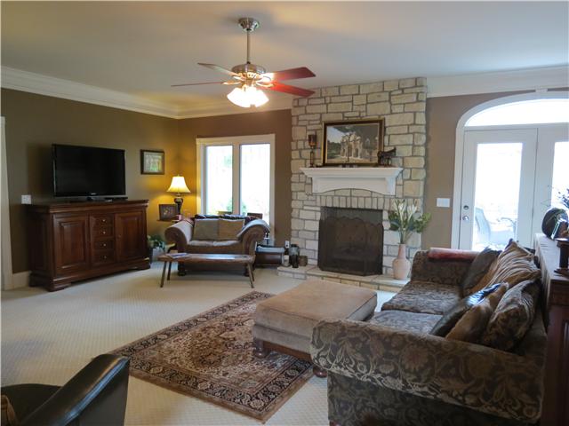 OPEN AND BRIGHT LIVING ROOM WITH A COZY FIREPLACE.   