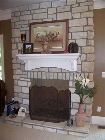 THIS IS A BEAUTIFUL STONE FIREPLACE WITH A NICE SET OF GAS LOGS!