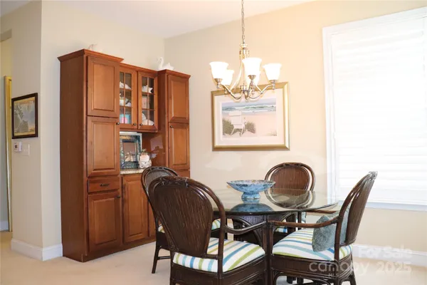 a view of a dining room with furniture and chandelier