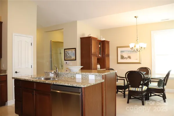 a bathroom with a granite countertop sink a mirror and a bathtub