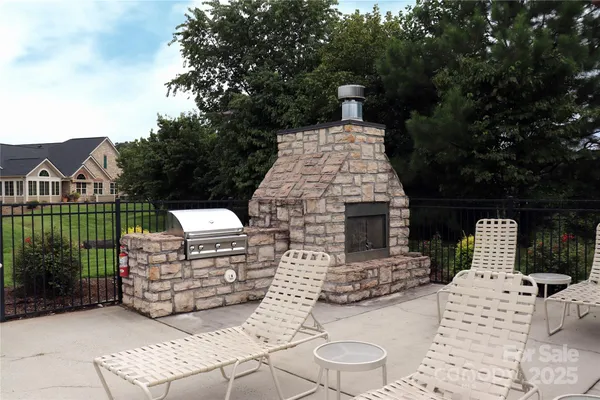 a view of a patio with couches table and chairs and potted plants