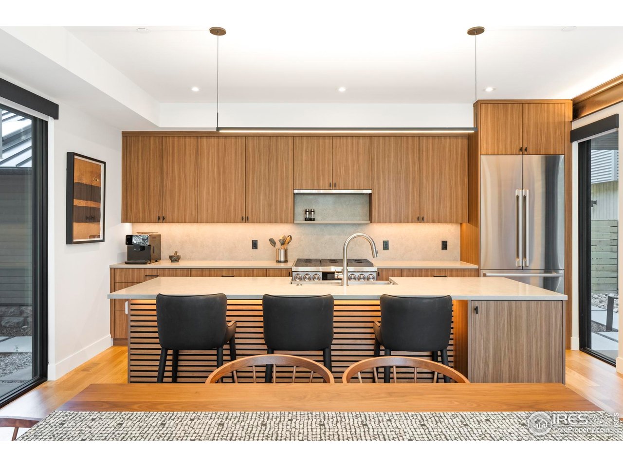 2709 Pine Street Boulder, CO 80302 - Photo 5 of 32 a kitchen with kitchen island granite countertop a stove a sink a refrigerator and wooden cabinets