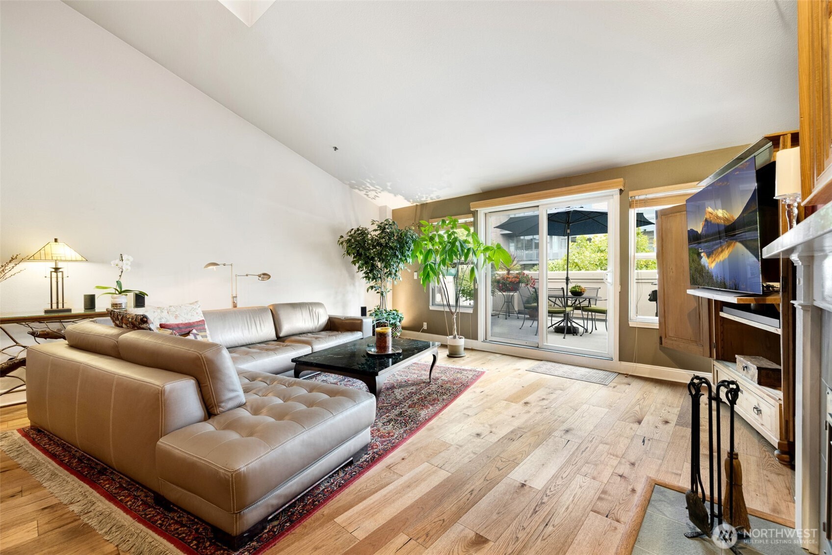 526 1st Avenue South, Unit 511 Seattle, WA 98104 - Photo 8 of 36 a living room with furniture a large window and a wooden floor