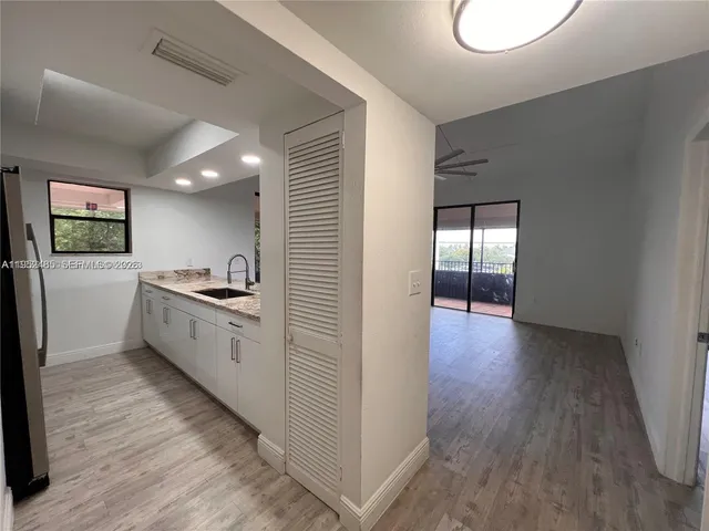 a kitchen with a refrigerator and a stove top oven