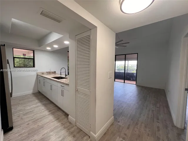 a kitchen with a refrigerator and a stove top oven