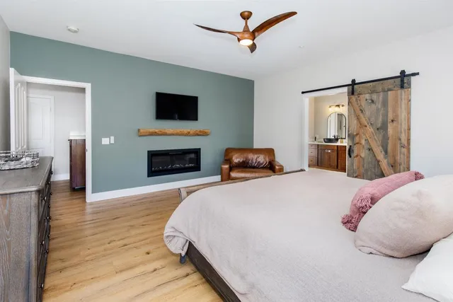 a bathroom with a granite countertop sink a mirror and bathtub