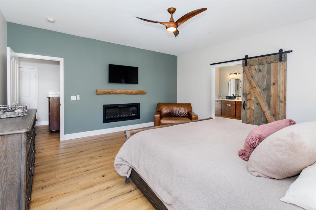 22544 Tombill Road Ramona, CA 92065 - Photo 17 of 74 a bedroom with a bed and a flat screen tv