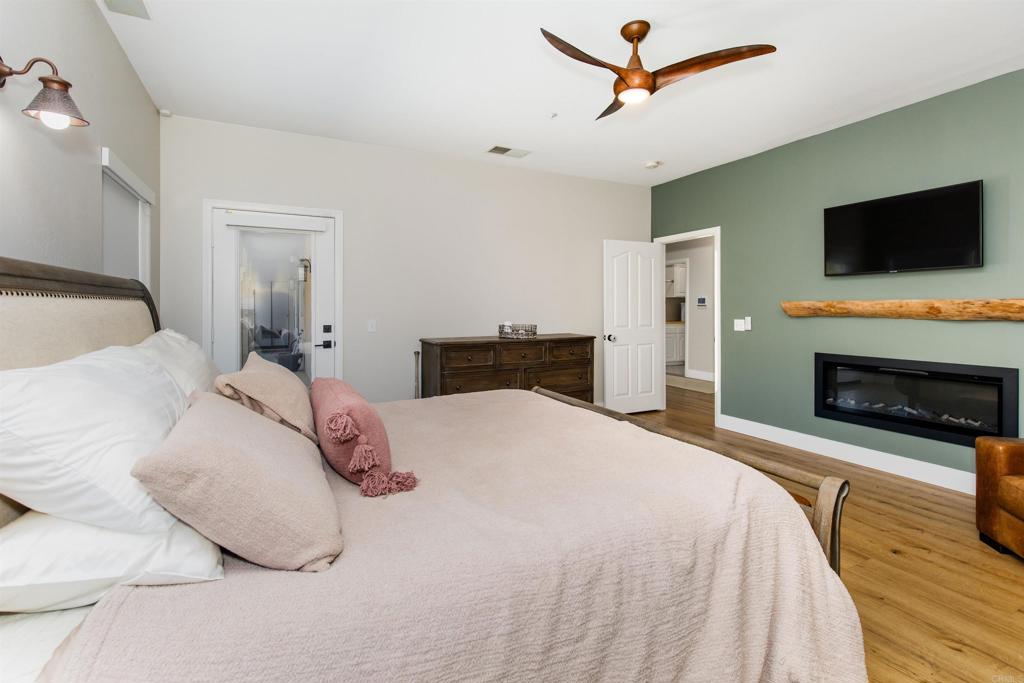 22544 Tombill Road Ramona, CA 92065 - Photo 18 of 74 a bedroom with a bed and a flat screen tv