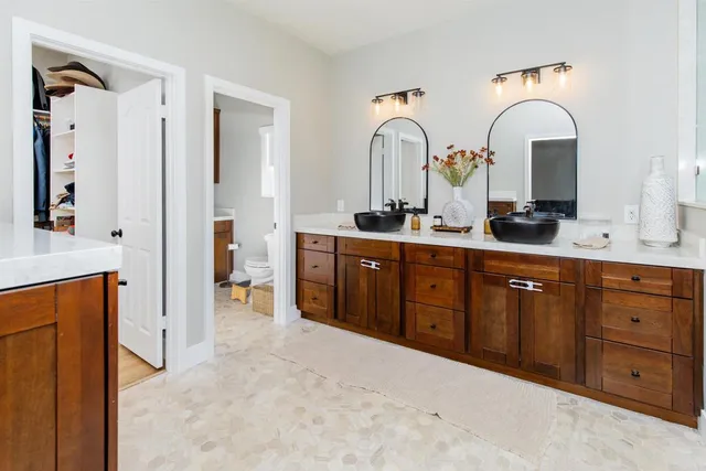 a large kitchen with stainless steel appliances a sink and cabinets