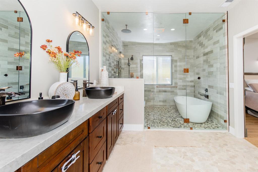 22544 Tombill Road Ramona, CA 92065 - Photo 20 of 74 a bathroom with a granite countertop sink a mirror and bathtub
