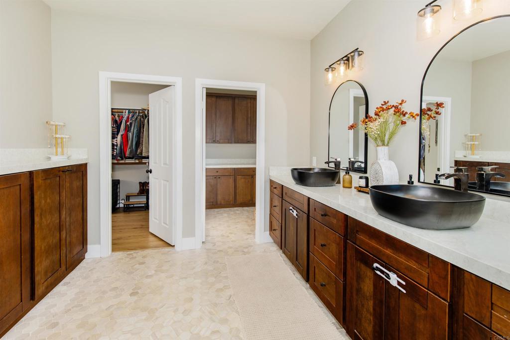 22544 Tombill Road Ramona, CA 92065 - Photo 22 of 74 a large kitchen with stainless steel appliances a sink and cabinets