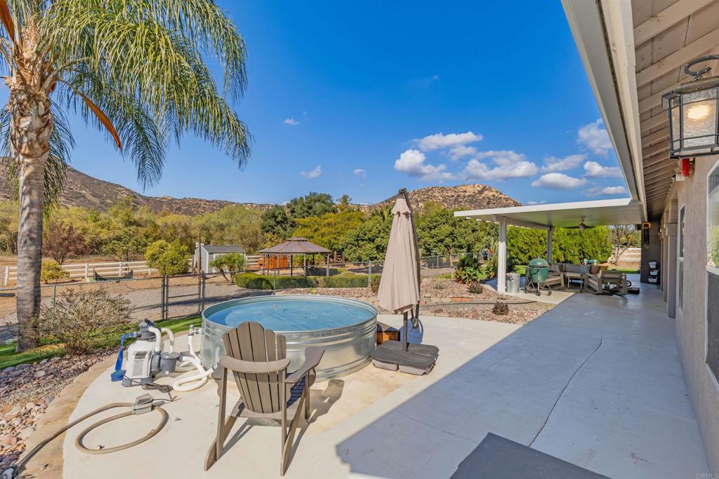 22544 Tombill Road Ramona, CA 92065 - Photo 34 of 74 a view of a patio with swimming pool table and chairs