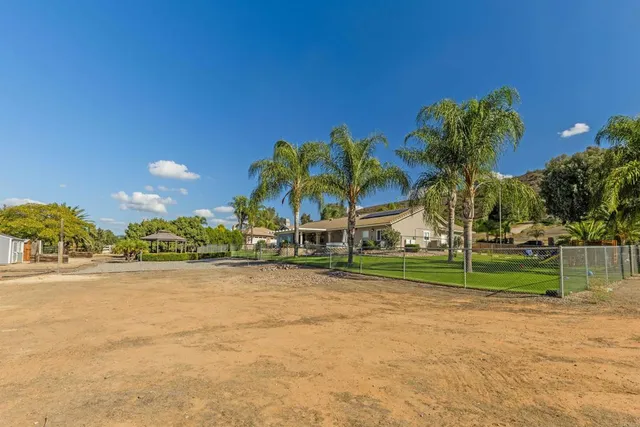 an aerial view of a residential houses with outdoor space