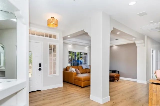 a living room with furniture fireplace and window