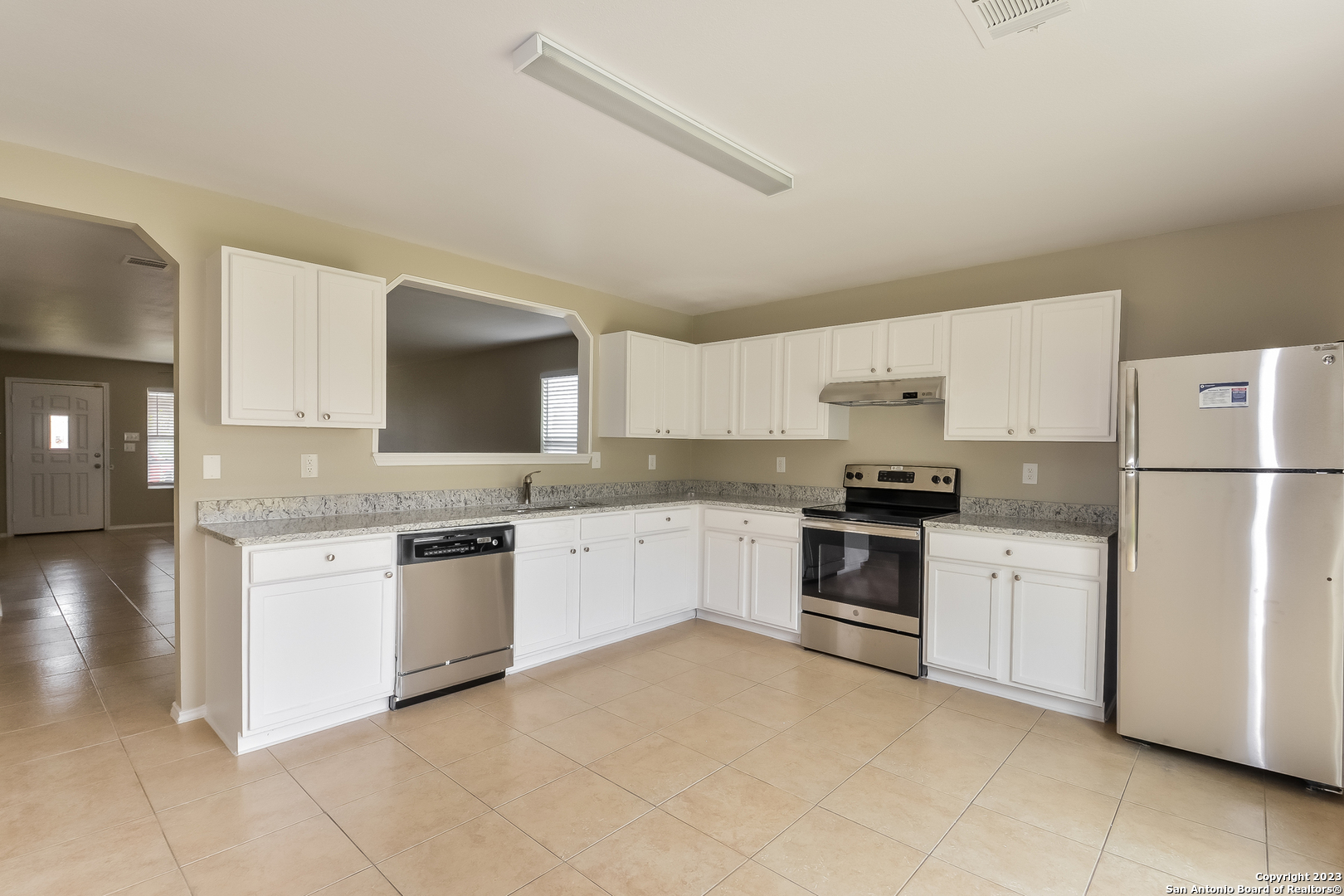315 Mallow Grove San Antonio, TX 78253 - Photo 4 of 15 a kitchen with granite countertop white cabinets and white appliances