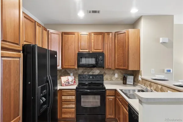a kitchen with a refrigerator stove and sink