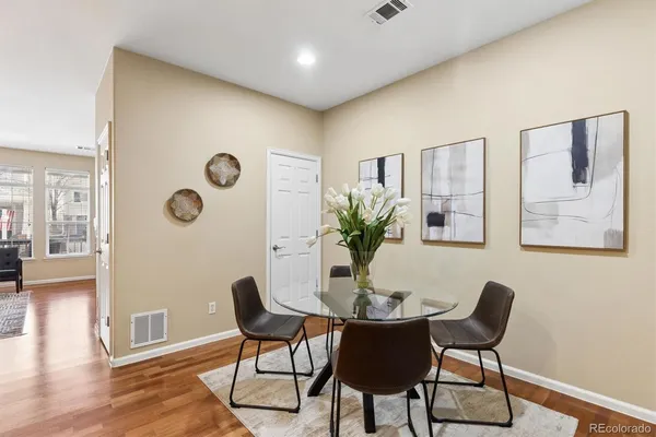 a dining room with furniture and wooden floor