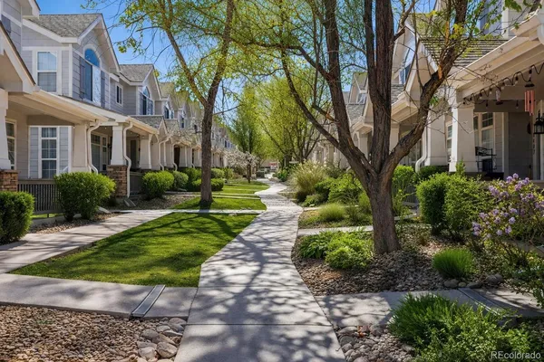 a front view of a house with a yard and green space