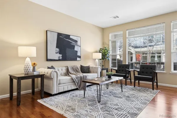 a living room with furniture and wooden floor